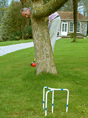 playing crolf behind tree